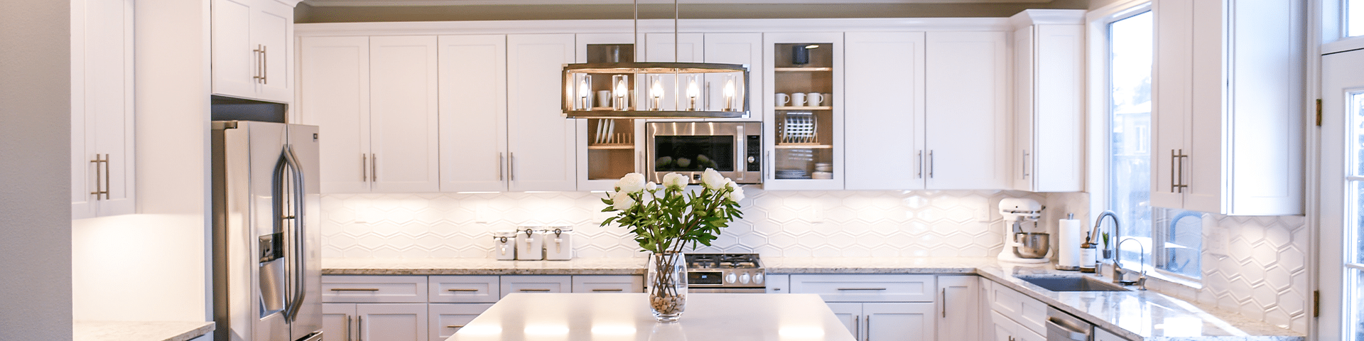white kitchen with chandelier